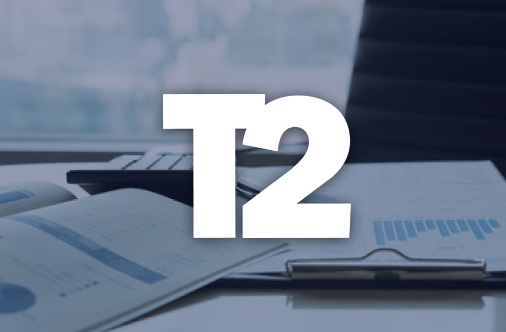 Take-Two-Logo vor Geschäftsunterlagen und einem Notebook, Symbolbild - Bild: Take-Two Interactive